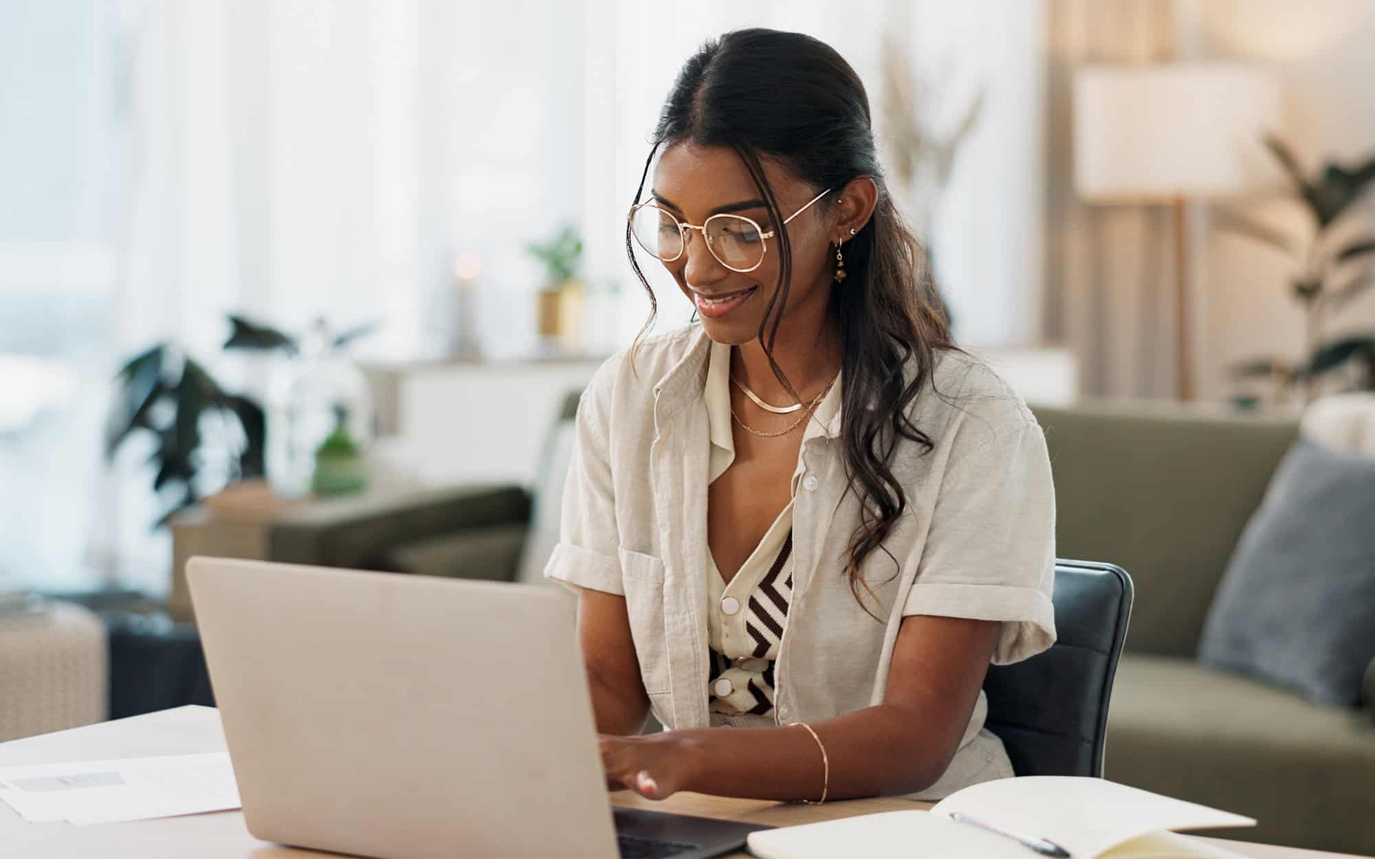 Woman Typing on Laptop in Home Office
