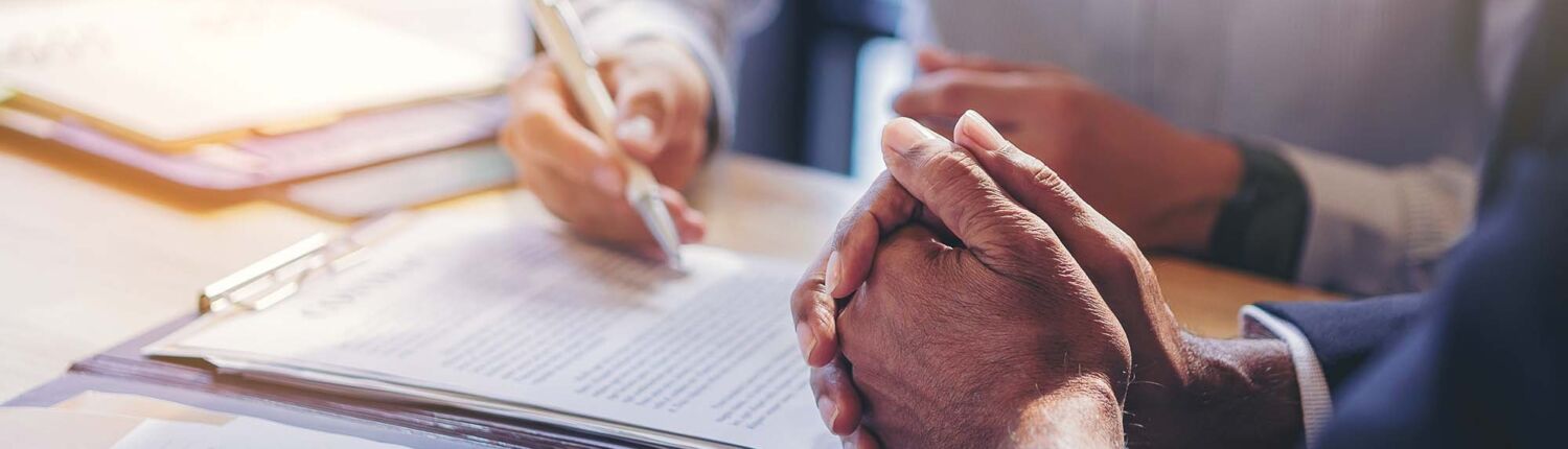 Business Person Being Shown Mortgage Paperwork