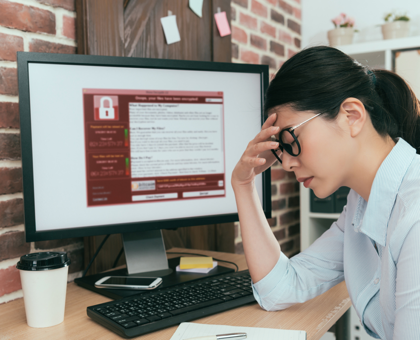 woman holding her head after a cyberattack