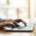 Female hands typing on laptop over blurred background