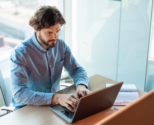 Worker focused at desk on computer